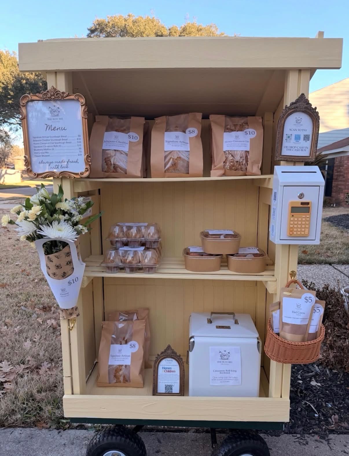 The Busy Bee Farmstand cart stocked with baked goods